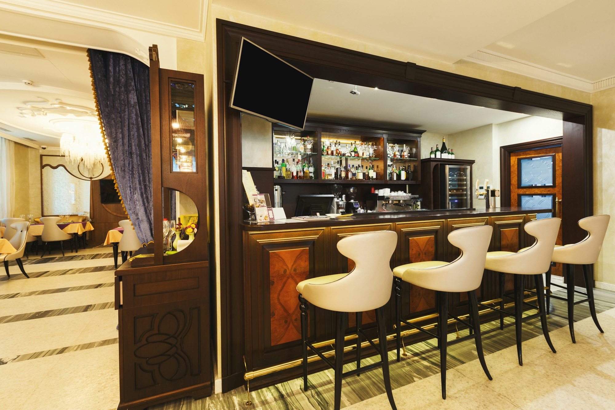 Hotel lounge bar with bottle shelfs and seats