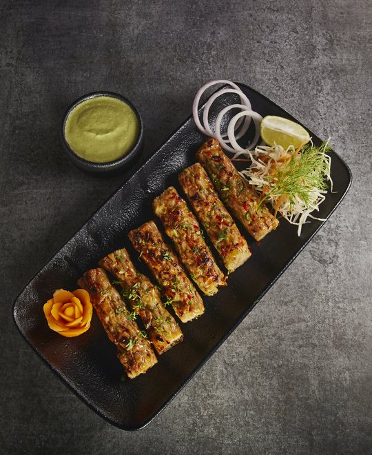 Juicy Chicken Seekh Kebab garnished with herbs and spices